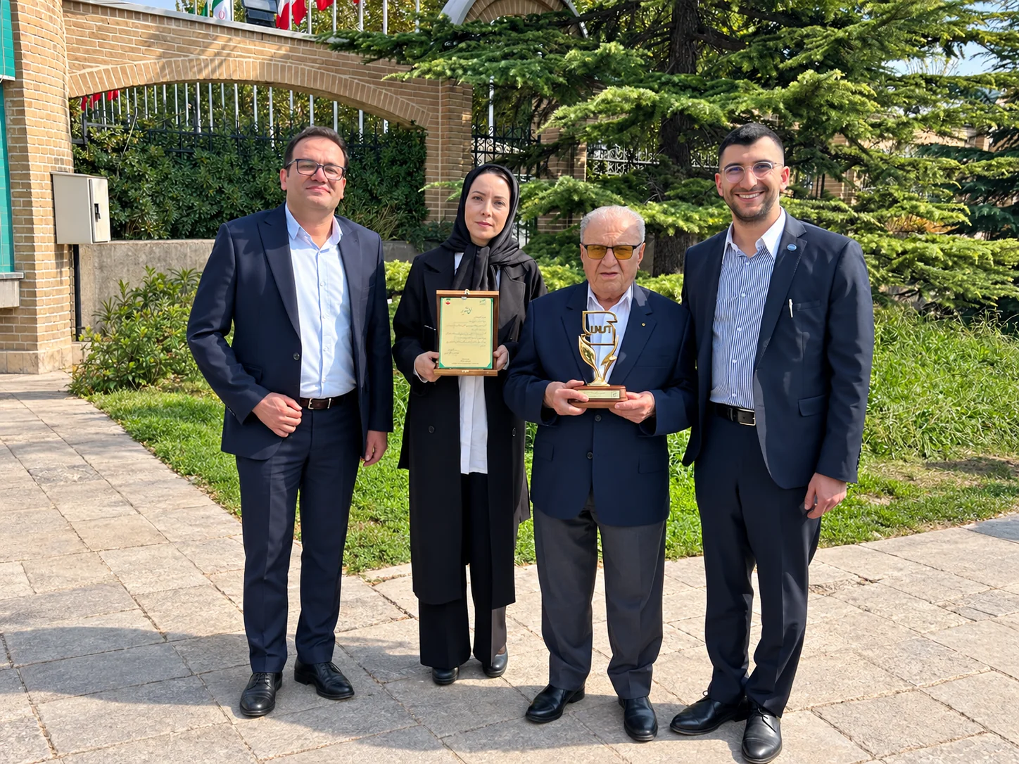 Behdash colleagues with the National Standard Award 2026 certificate and trophy